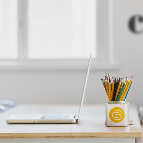 Laptop and desk tidy on a desk